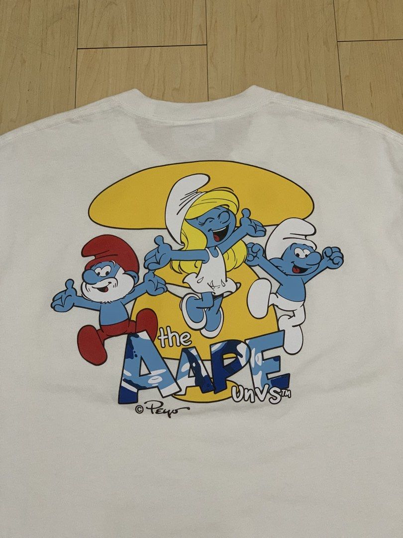 AAPE x SMURFS TEE (Category: Tshirts & Polo Shirts ) located in Manila. Submitted by scarlett_hope (Listing ID 1470609716, Image 3). Description: A•PE x SMURFS TEE (Hard to find) L: 28 W: 21 Color rate: 9.8/10 Condition: Excellent Price: 📩📩📩 📍Manila.