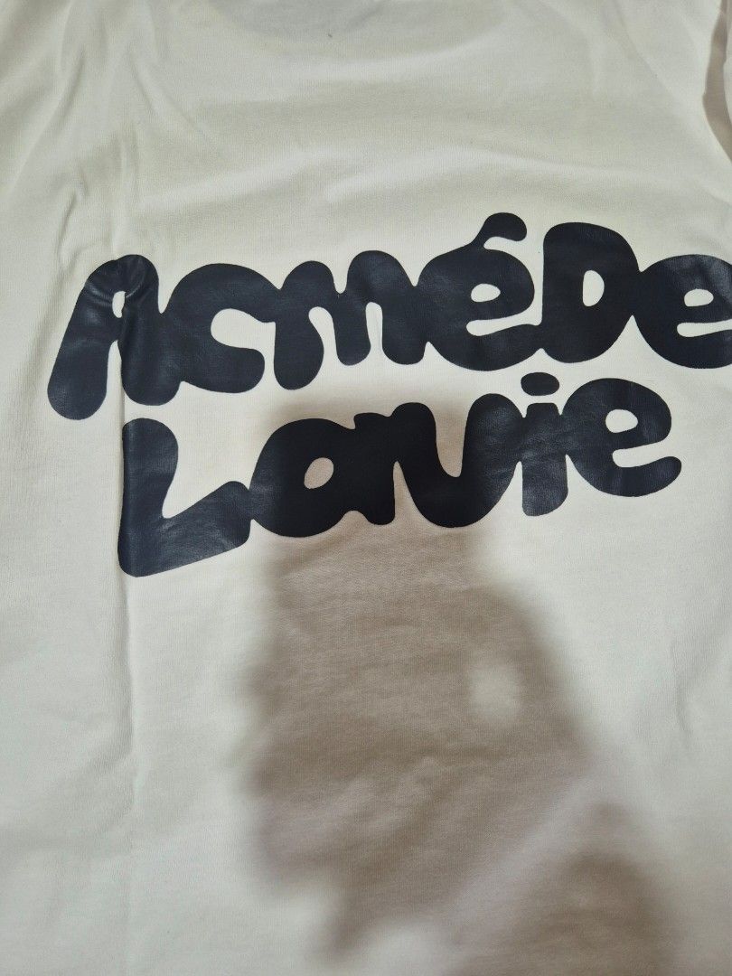acmé de la vie ADLV Bearbrick Tee (Category: Shirts) located in Daraga. Submitted by nvdp118255967 (Listing ID 1470622475, Image 3). Description: - Authentic ADLV (acmé de la vie) white t-shirt - Features iconic Big Bearbrick graphic print on the front - Classic crew neck and short sleeves design - Made from premium, soft cotton fabric - Includes original interior collar tag and care label - Clean condition: guaranteed no stains, holes, or flaws.