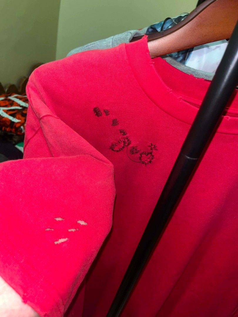 Acne Studios Distressed Red T-Shirt (Category: Tshirts & Polo Shirts ) located in Tuguegarao City. Submitted by ZeevLim (Listing ID 1470700964, Image 2). Description: - Brand: Acne Studios - Material: 100% organically grown cotton - Color: Bright red - Fit: Relaxed - Design: Distressed details throughout the collar, shoulders, hem, and minor tears on sleeves for a vintage, heavily worn look - Branding: Embroidered Acne Studios logo across the bac