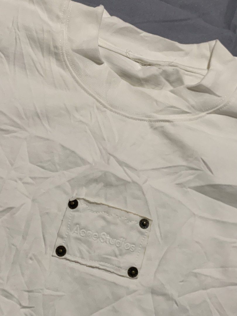 Acne Studios White T-Shirt with Embroidered Pocket Patch (Category: Luxury Apparel) located in General Santos City (Dadiangas). Submitted by stockyards (Listing ID 1470589703, Image 2). Description: - Brand: Acne Studios - Color: White - Fit: Oversized, relaxed drop shoulder - Material: Premium heavy cotton - Details: Chest pocket patch with embroidered logo and four metal rivets - Measurements: ~22" chest width, ~29.5" length.