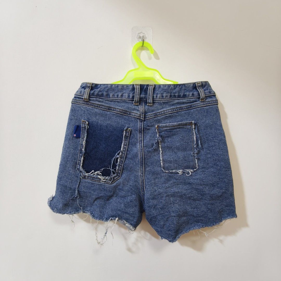 Ader Error 2020SS Denim Shorts Leather Card Holder Size A2 (Category: Shorts) located in Quezon City. Submitted by inrelationthrift (Listing ID 1470675024, Image 2). Description: - Brand: Ader Error (2020 Spring/Summer Collection) - Size: A2 (Waist: ~14 inches flat) - Material: 100% Cotton - Color: Blue - Details: Distressed frayed hems, unique patchwork pocket design, and front leather cardholder accent - Condition: Cleanly stored, excellent str
