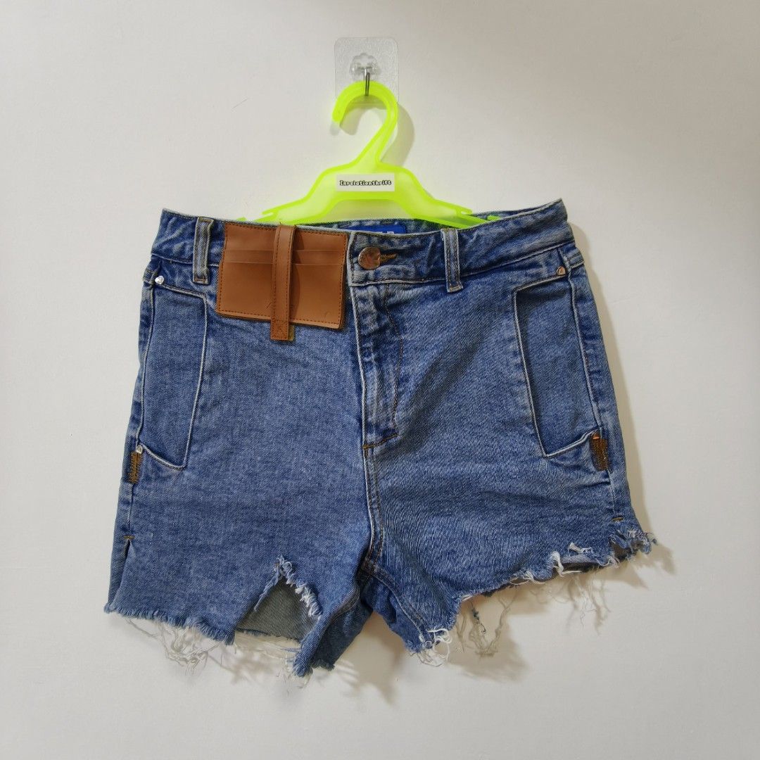 Ader Error 2020SS Denim Shorts Leather Card Holder Size A2 (Category: Shorts) located in Quezon City. Submitted by inrelationthrift (Listing ID 1470675024, Image 1). Description: - Brand: Ader Error (2020 Spring/Summer Collection) - Size: A2 (Waist: ~14 inches flat) - Material: 100% Cotton - Color: Blue - Details: Distressed frayed hems, unique patchwork pocket design, and front leather cardholder accent - Condition: Cleanly stored, excellent str