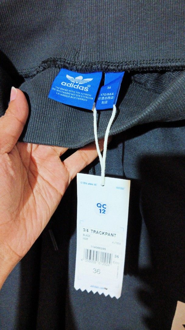 Adidas 3/4 Track Pant Black Size 36 (Category: Joggers) located in Manila. Submitted by zambee16 (Listing ID 1470665925, Image 2). Description: - Brand: Adidas - Item: 3/4 Track Pants - Color: Black with white logo print - Condition: Brand new with original tags attached - Features: Elastic drawstring waist and trendy raw hem cuffs - Perfect for casual wear or workouts.
