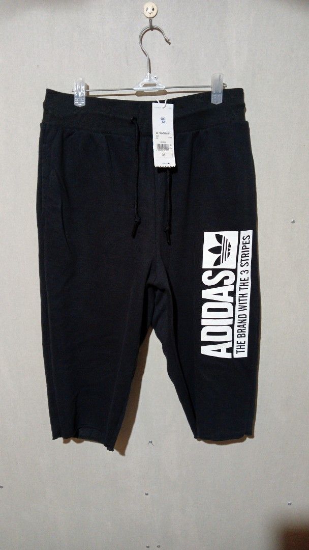 Adidas 3/4 Track Pant Black Size 36 (Category: Joggers) located in Manila. Submitted by zambee16 (Listing ID 1470665925, Image 1). Description: - Brand: Adidas - Item: 3/4 Track Pants - Color: Black with white logo print - Condition: Brand new with original tags attached - Features: Elastic drawstring waist and trendy raw hem cuffs - Perfect for casual wear or workouts.