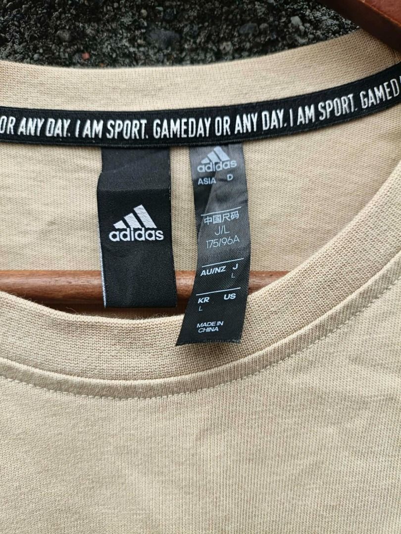 Adidas beige pocket t-shirt (Category: Tshirts & Polo Shirts ) located in Aloran. Submitted by shangzr (Listing ID 1470560146, Image 3). Description: - Brand: Adidas - Color: Beige (Neutral earth tone) - Size: L (175/96A) - Fit: Casual, short sleeves - Details: Left chest pocket, black logo patch on left sleeve, branded interior collar tape - Origin: Made in China - Condition: Excellent.