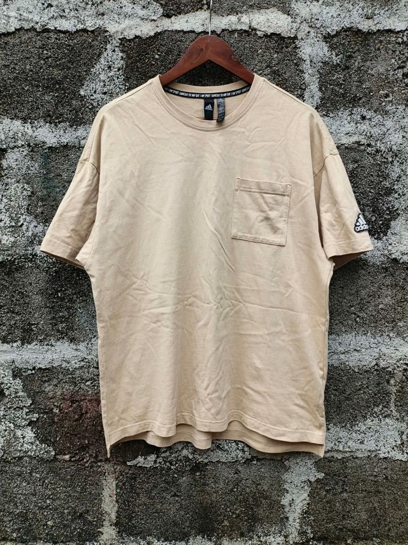 Adidas beige pocket t-shirt (Category: Tshirts & Polo Shirts ) located in Aloran. Submitted by shangzr (Listing ID 1470560146, Image 1). Description: - Brand: Adidas - Color: Beige (Neutral earth tone) - Size: L (175/96A) - Fit: Casual, short sleeves - Details: Left chest pocket, black logo patch on left sleeve, branded interior collar tape - Origin: Made in China - Condition: Excellent.