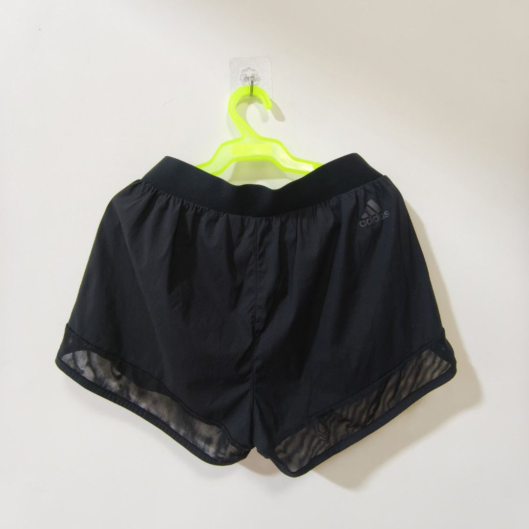 Adidas Black Athletic Shorts with Mesh Trim (Category: Shorts) located in Quezon City. Submitted by inrelationthrift (Listing ID 1470673258, Image 3). Description: - Brand: Adidas - Color: Classic Black - Design: Large logo on the front with mesh detailing along the bottom hem sides - Waistband: Elastic with adjustable drawstring for a secure fit - Measurements (Flat Lay): Waist approx. 13.5 inches | Length approx. 12 inches - Condition: Excellen