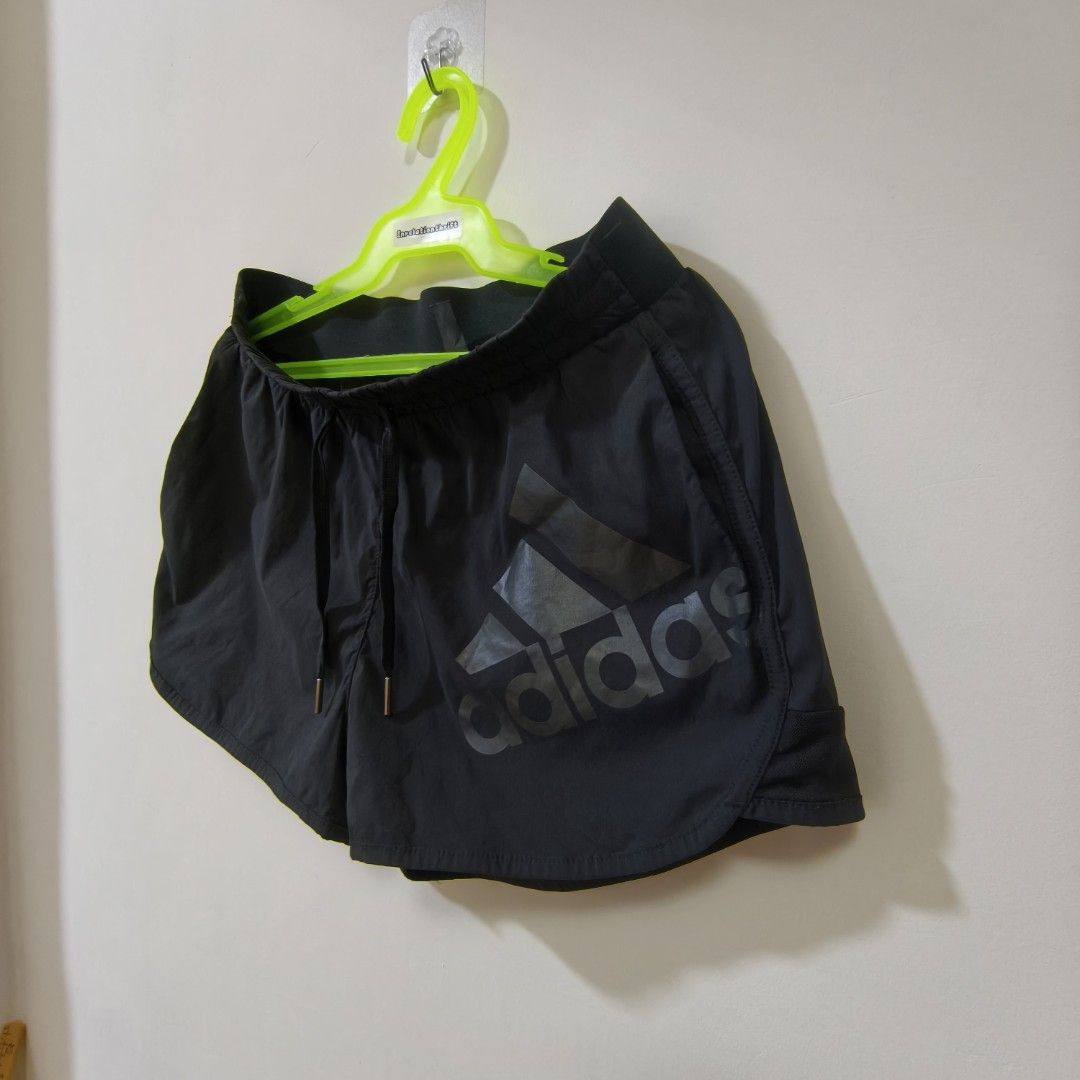 Adidas Black Athletic Shorts with Mesh Trim (Category: Shorts) located in Quezon City. Submitted by inrelationthrift (Listing ID 1470673258, Image 2). Description: - Brand: Adidas - Color: Classic Black - Design: Large logo on the front with mesh detailing along the bottom hem sides - Waistband: Elastic with adjustable drawstring for a secure fit - Measurements (Flat Lay): Waist approx. 13.5 inches | Length approx. 12 inches - Condition: Excellen