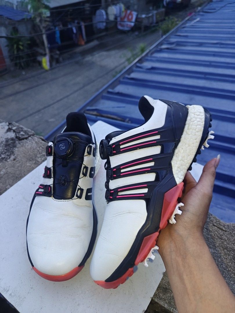 Adidas Boost Golf Shoes with Boa Lacing System (Category: Golf) located in Davao. Submitted by judethrifter (Listing ID 1470689836, Image 1). Description: - Brand: Adidas Golf - Colorway: White, black, and red with stylish pink accent stripes - Closure: Boa dial lacing system for quick and secure adjustments - Cushioning: Visible Boost midsole with 'boost endless energy' printed insoles - Soles: Removable spiked soles featuring a red and white gr