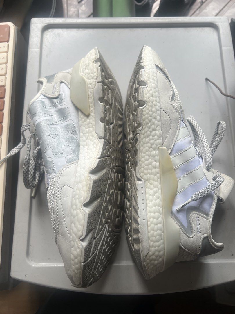 Adidas Nite Jogger White Grey Boost Sneakers (Category: Sneakers) located in Manila. Submitted by manimtim.joy (Listing ID 1470586023, Image 2). Description: - Brand/Model: Adidas Nite Jogger (White and Grey) - Materials: Mesh upper with stylish suede and leather overlays - Comfort: Thick Boost midsole for all-day cushioning - Special Features: Reflective laces and side panels that glow in the light - Condition: Worn a few times, normal dirt on s