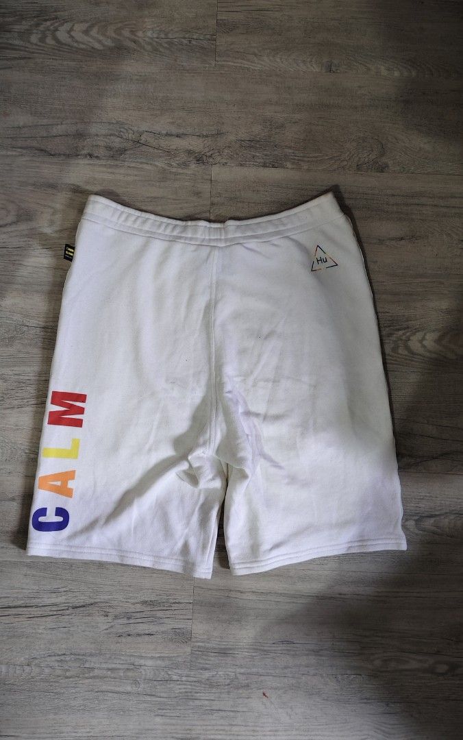 Adidas Pharrell Williams Hu Sun Calm Shorts (Category: Shorts) located in Quezon City. Submitted by truedeer_cda94c (Listing ID 1470602562, Image 2). Description: - Authentic Adidas Pharrell Williams collection - Color: Crisp white with multi-color details - Design: 'SUN' and 'CALM' text on legs, Hu triangle logo on back - Storage: Secure side zip pockets with adjustable drawstring waistband - Details: Colorful embroidered Adidas trefoil tag - Ma