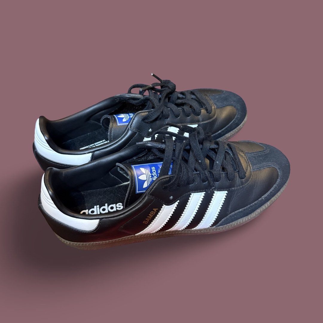 Adidas Samba Black White Sneakers (Category: Sneakers) located in Quezon City. Submitted by chey.mayuga (Listing ID 1470654731, Image 2). Description: - Authentic black and white Adidas Samba sneakers - Classic leather upper with stylish suede toe overlays - Eye-catching blue tongue label with the Trefoil logo - Signature metallic gold 'SAMBA' lettering on the side - Durable gum rubber soles for everyday wear - Comes with classic black laces - Ve