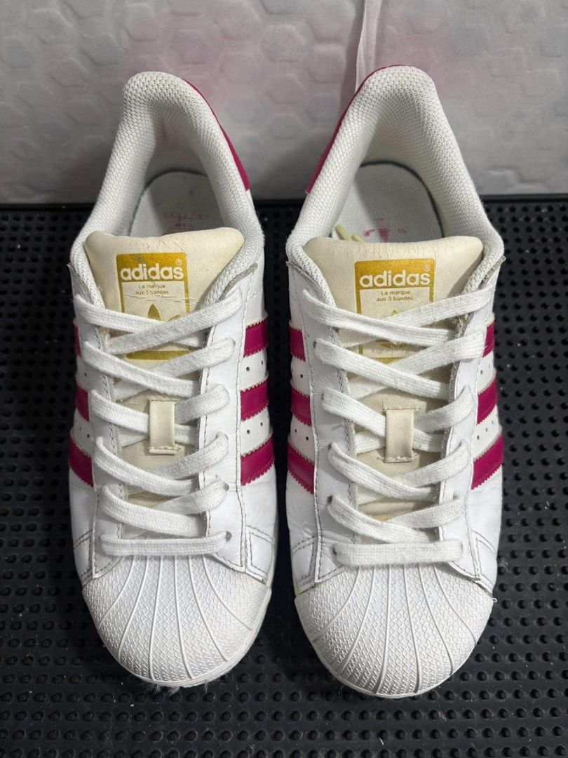 Adidas SUPERSTAR White with Pink Stripes (Category: Sneakers) located in Paranaque City. Submitted by julianneski (Listing ID 1470740615, Image 1). Description: •Brand: Adidas Superstar •Inclusions: White laces and un-yellow the soles which makes it look brand new •Size: US 5 • Model: Adidas Superstar J (Junior / Youth sizing) • Colorway: Super Pink • Upper Material: Leather • Category: Lifestyle / Low-top • Features: Classic rubber shell toe and