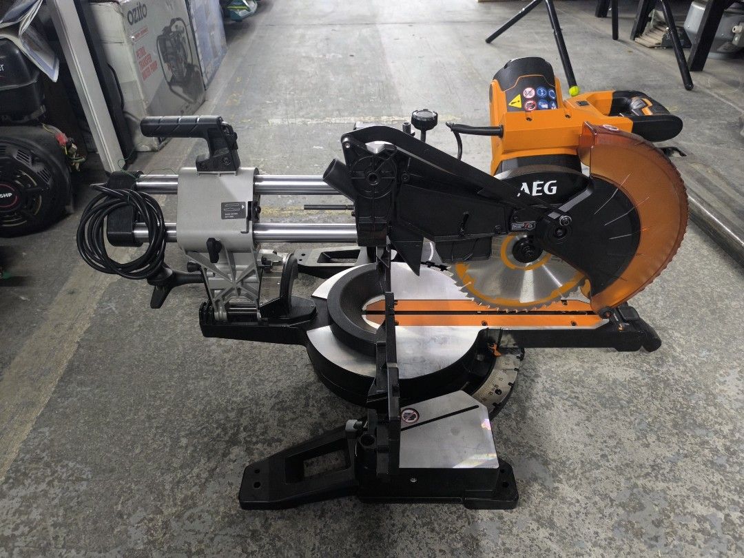 AEG Sliding Mitre Saw Power Tool 1800W (Category: Construction Tools & Equipment) located in Dasmarinas. Submitted by bossgabo (Listing ID 1470586808, Image 1). Description: - Brand: AEG - Type: Corded electric sliding compound mitre saw - Color: Striking orange and black - Capacity: Dual slide rails for wider cuts - Safety: Clear orange blade guard - Precision: Adjustable bevel and mitre settings - Build: Heavy-duty construction with a sturdy me