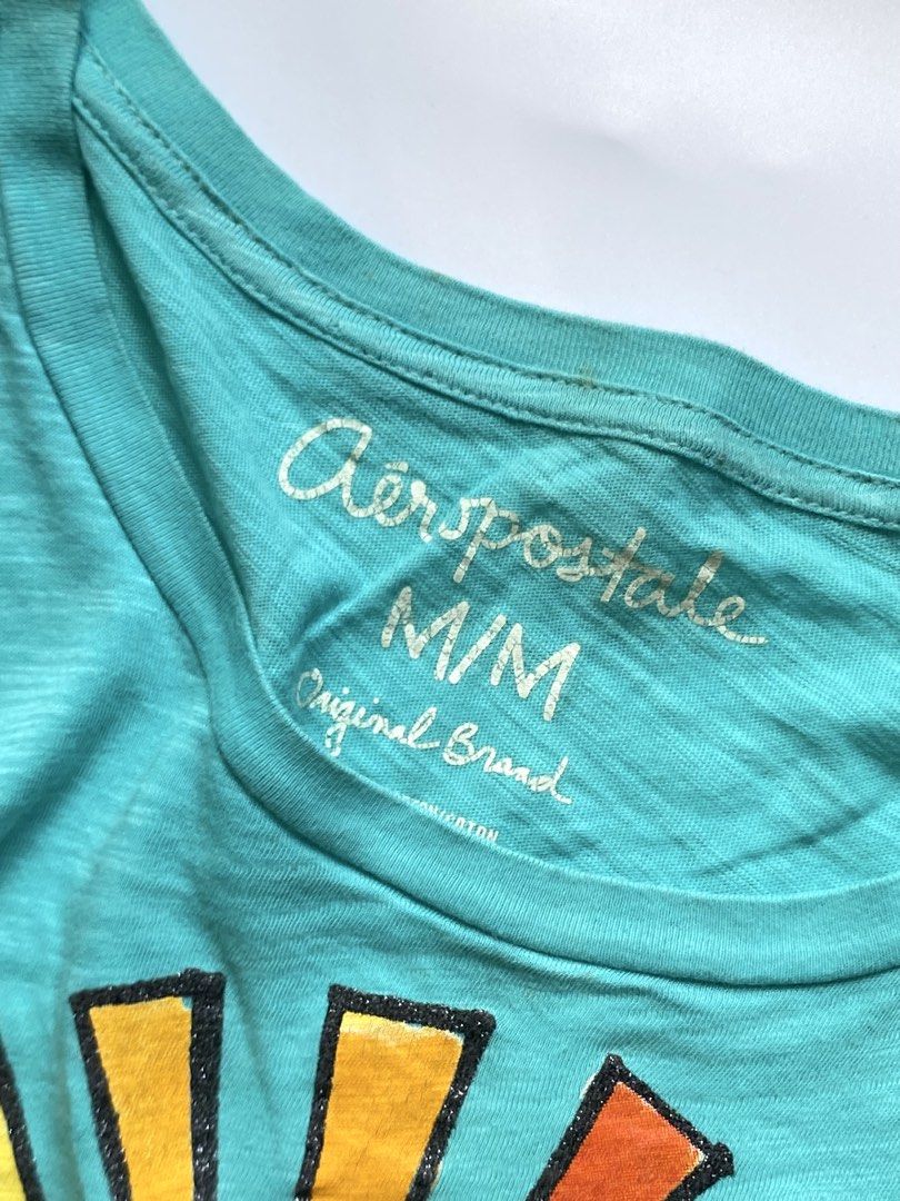 Aeropostale Turquoise Graphic Tee (Category: Tshirts & Polo Shirts ) located in Manila. Submitted by petalfinds_ (Listing ID 1470647126, Image 2). Description: ˚⊱🪷⊰˚ summer teal shirt ౨ৎ 𝐛𝐫𝐚𝐧𝐝: aeropostale ౨ৎ 𝐬𝐢𝐳𝐞: small to medium 🫧⋆｡˚ 𝐝𝐞𝐭𝐚𝐢𝐥𝐬: PRETTYYY! with stains lang siya. not sure if washableee since not washed pa yung item 💞 aside from that, wala nang issue! 🪷 ─── ⋆⋅☆⋅⋆ ── 「 ✦ 𝐍𝐎 𝐂𝐎𝐃𝐄, 𝐈𝐍𝐕𝐀𝐋𝐈𝐃 𝐌𝐈𝐍𝐄 ✦ 」 �