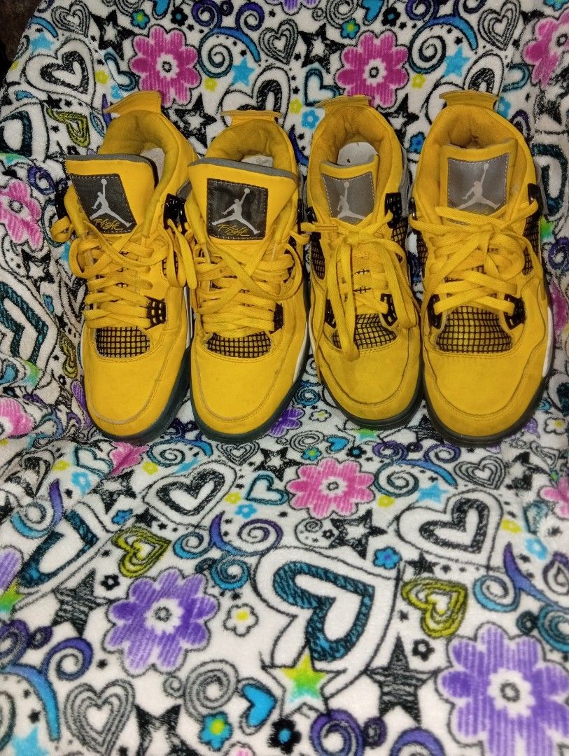 Air Jordan 4 Yellow Thunder (Category: Sneakers) located in Manila. Submitted by kramchelle (Listing ID 1470723414, Image 2). Description: - Model: Air Jordan 4 - Colorway: Vibrant yellow and black with grey wing accents - Branding: Iconic Jumpman logo on the tongue and heel - Condition: Uppers are in decent overall shape; soles show visible dirt and wear from use - Features: Classic mesh panels.