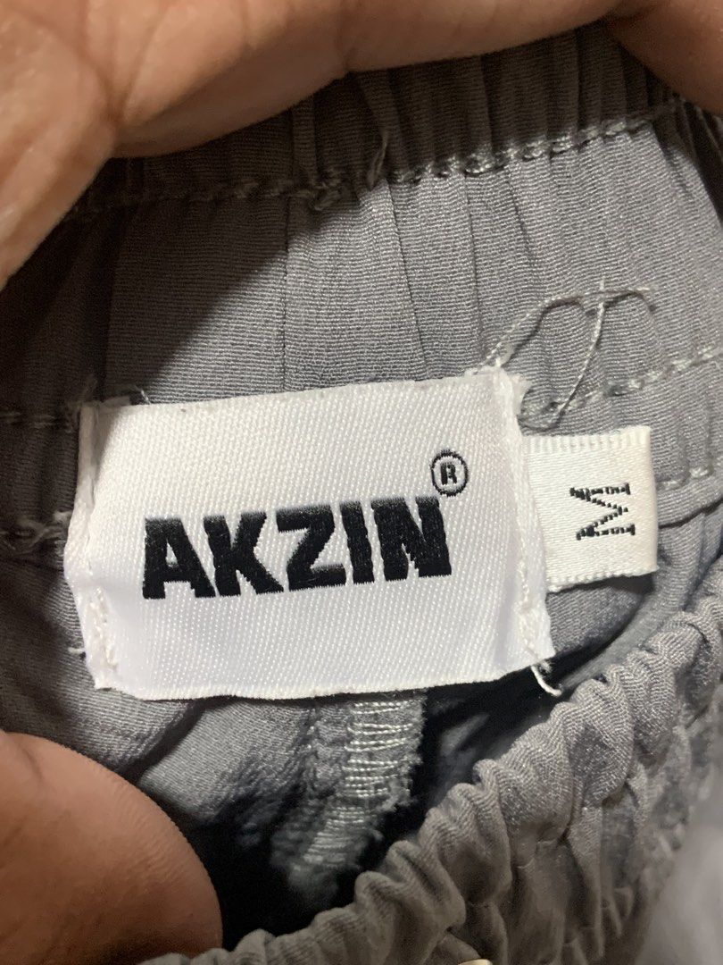Akzin Grey Athletic Shorts Size M. -missing lace (Category: Activewear) located in Angeles City. Submitted by manlapidma26771 (Listing ID 1470579095, Image 2). Description: - Brand/Model: Akzin grey athletic shorts - Size: Medium - Waistband: Elastic with metal eyelets - Pockets: Secure zipped side pockets with premium YKK zippers - Details: Small white AK logo near the hem and triangle hardware loop near the left pocket.