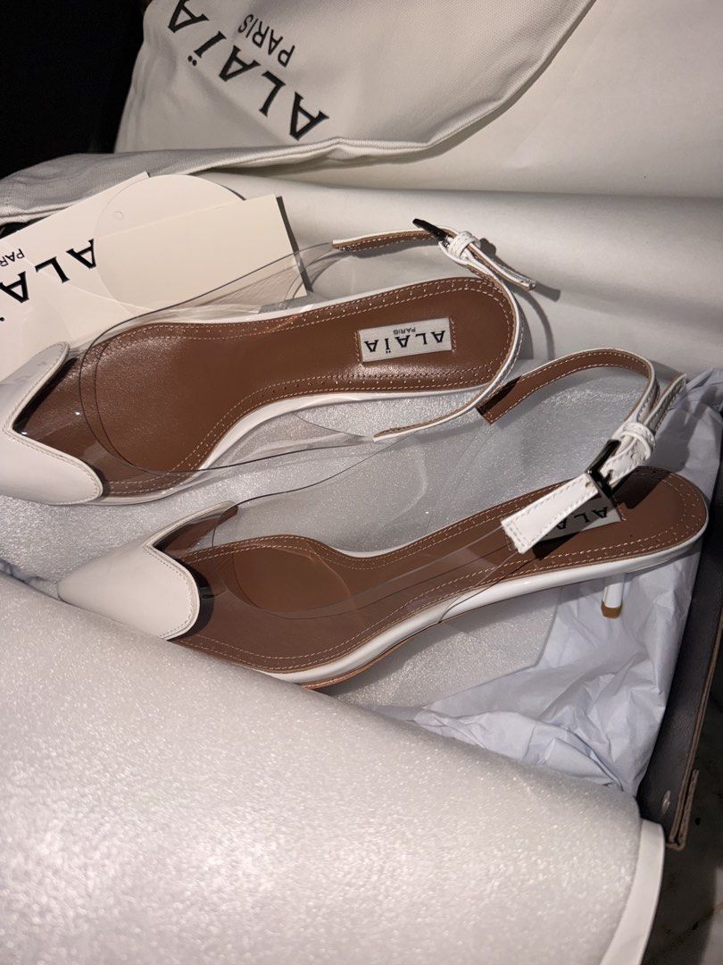 Alaïa Paris White and Clear Slingback Heels Size 41 (Category: Heels) located in Las Pinas. Submitted by twiceloved24 (Listing ID 1470638446, Image 3). Description: - Brand: Alaïa Paris - Style: Slingback kitten heels with pointed toe and adjustable buckle ankle strap - Materials: Clear PVC, white trim, and premium brown leather inner soles - Size: EU 41 - Origin: Made in Italy - Inclusions: Original dust bag and box - Condition: Excellent/Like n