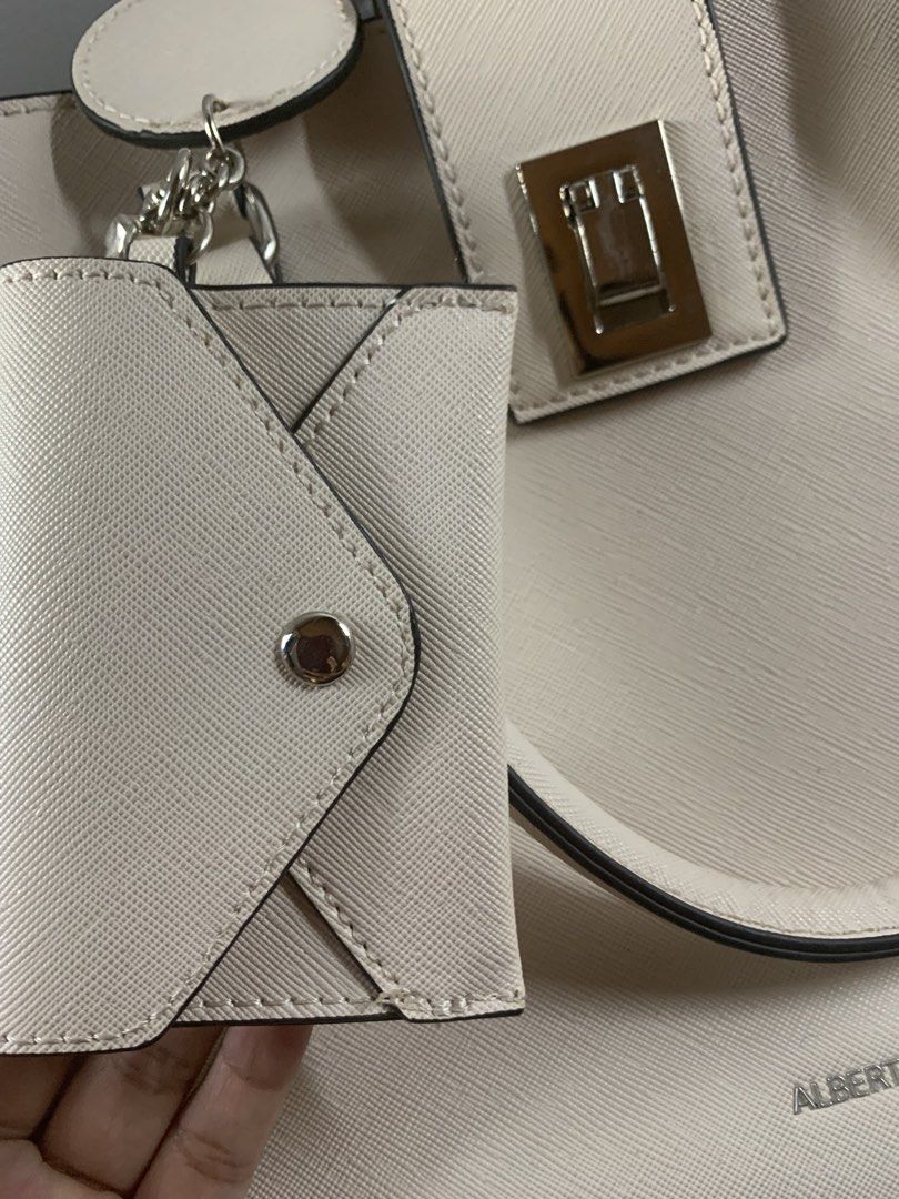 ALBERTO cream structured handbag with mini pouch (Category: Shoulder Bags) located in Manila. Submitted by luckybird-488263 (Listing ID 1470693259, Image 2). Description: - Brand: ALBERTO - Color: Cream - Material/Texture: Saffiano-style texture - Hardware: Silver-toned with secure turn-lock closure - Handles: Double top handles with sleek black edging - Inclusion: Matching mini envelope-style pouch attached by a chain strap - Condition: Pristine