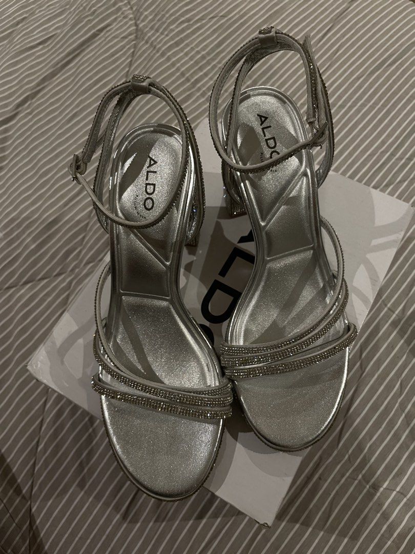 ALDO Silver Rhinestone Strappy Block Heels (Category: Heels) located in Las Pinas. Submitted by francesaly (Listing ID 1470724310, Image 1). Description: COMES WITH BOX/DUSTBAG (only used once) Glamorous silver high heels from ALDO with sparkling rhinestone-embellished straps and a comfortable block heel. Includes Pillow Walk technology insoles for extra comfort during long events! Perfect for weddings, prom, formals, or night outs.