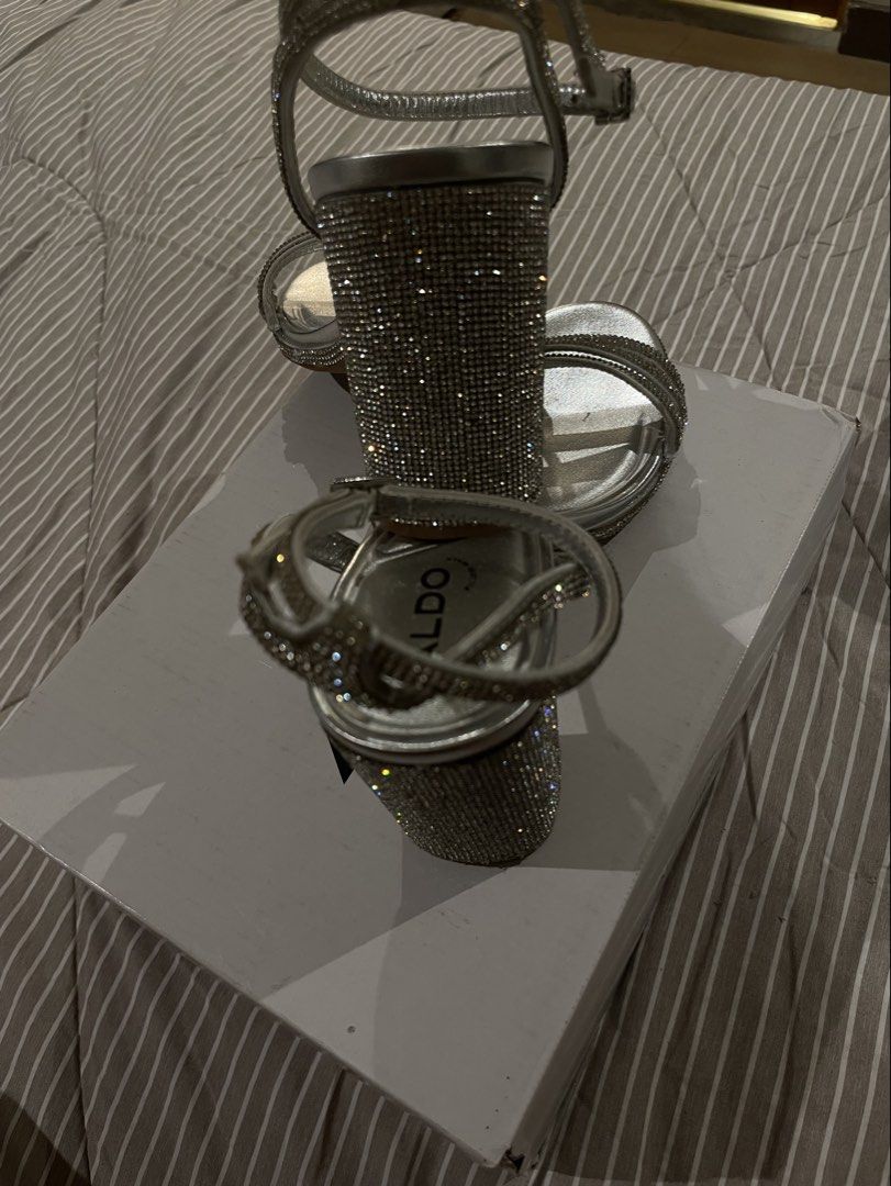 ALDO Silver Rhinestone Strappy Block Heels (Category: Heels) located in Las Pinas. Submitted by francesaly (Listing ID 1470724310, Image 3). Description: COMES WITH BOX/DUSTBAG (only used once) Glamorous silver high heels from ALDO with sparkling rhinestone-embellished straps and a comfortable block heel. Includes Pillow Walk technology insoles for extra comfort during long events! Perfect for weddings, prom, formals, or night outs.