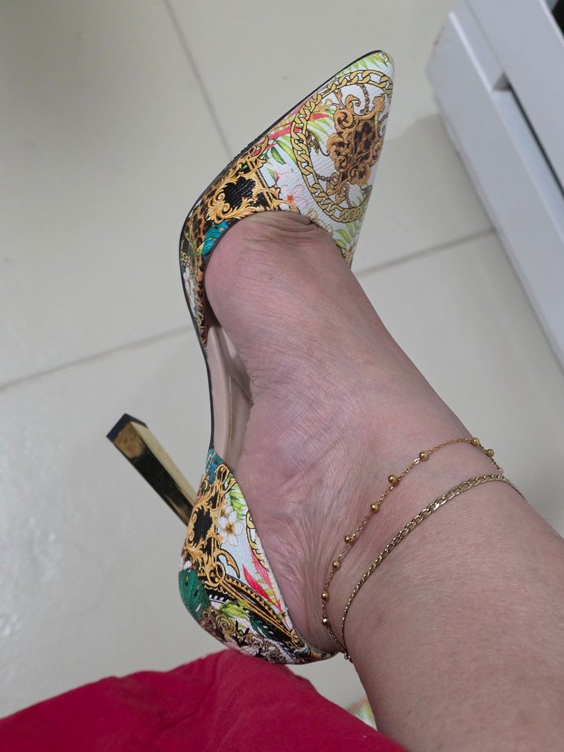 ALDO Tropical Baroque Print High Heels (Category: Heels) located in Taguig. Submitted by m_lim (Listing ID 1470717858, Image 2). Description: - Brand: ALDO - Style: High heels with pointed toe and gold metallic stiletto heel - Design: Striking tropical baroque print mixing leopard print, gold chains, and vibrant green leaves - Comfort: Cushioned insoles for all-day wear - Condition: Worn once or twice, minor wear on soles - Perfect statement shoe