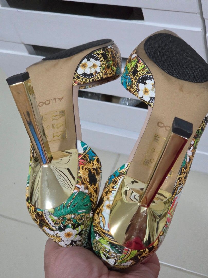 ALDO Tropical Baroque Print High Heels (Category: Heels) located in Taguig. Submitted by m_lim (Listing ID 1470717858, Image 3). Description: - Brand: ALDO - Style: High heels with pointed toe and gold metallic stiletto heel - Design: Striking tropical baroque print mixing leopard print, gold chains, and vibrant green leaves - Comfort: Cushioned insoles for all-day wear - Condition: Worn once or twice, minor wear on soles - Perfect statement shoe
