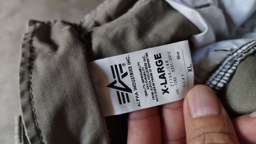 Alpha Industries Cargo Pants Olive Green XL (Category: Joggers) located in Quezon City. Submitted by truedeer_cda94c (Listing ID 1470606791, Image 3). Description: - Brand: Alpha Industries - Color: Olive Green - Size: XL (Waist: 86cm) - Style: Classic military fit with heavy-duty construction - Features: Multiple utility pockets with secure button flaps - Details: Signature Alpha Industries woven patch on side pocket and back label.