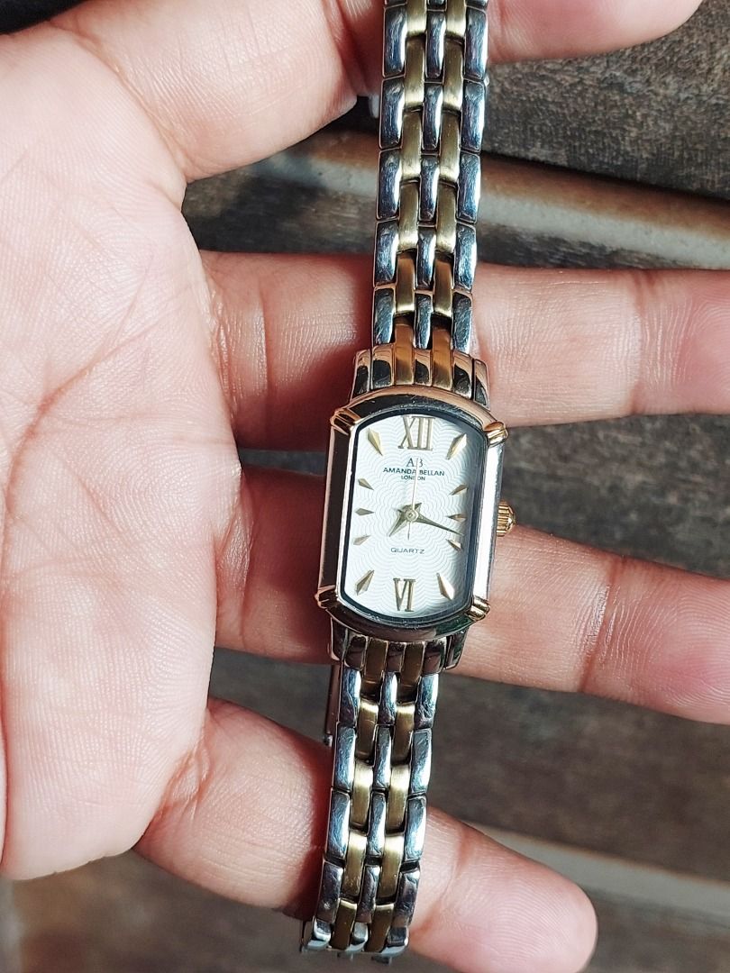 Amanda Bellan AB-216L Two-Tone Quartz Watch (Category: Women's Watches) located in Batangas. Submitted by vintageanddainty (Listing ID 1470587744, Image 1). Description: - Brand/Model: Amanda Bellan AB-216L - Movement: Reliable Japan quartz movement - Design: Rectangular dial with Roman numerals at 12 and 6 - Strap: Two-tone silver and gold stainless steel bracelet - Features: Water-resistant build - Condition: Back casing has multiple scratches 