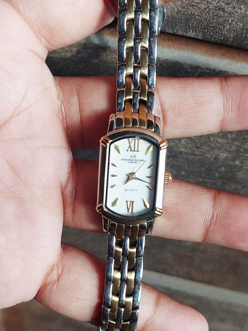 Amanda Bellan AB-216L Two-Tone Quartz Watch (Category: Women's Watches) located in Batangas. Submitted by vintageanddainty (Listing ID 1470587744, Image 2). Description: - Brand/Model: Amanda Bellan AB-216L - Movement: Reliable Japan quartz movement - Design: Rectangular dial with Roman numerals at 12 and 6 - Strap: Two-tone silver and gold stainless steel bracelet - Features: Water-resistant build - Condition: Back casing has multiple scratches 