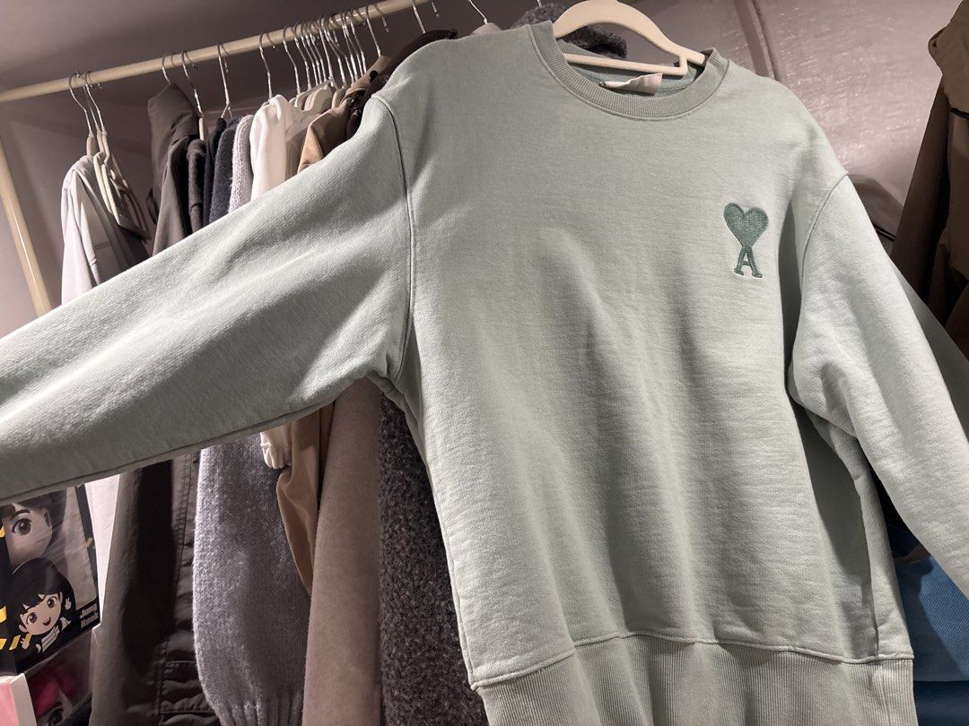 Ami Paris Green Heart Logo Sweatshirt (Category: Coats, Jackets and Outerwear) located in Tarlac. Submitted by somethinboutgyu (Listing ID 1470675701, Image 2). Description: - Brand: Ami Paris - Color: Mint Green - Condition: Like new (worn once for photos) - Features: Embroidered tonal heart & A logo, classic crewneck, ribbed cuffs and hem - Material: Soft, premium cotton - Origin: Made in Portugal - Fit: Relaxed fit.