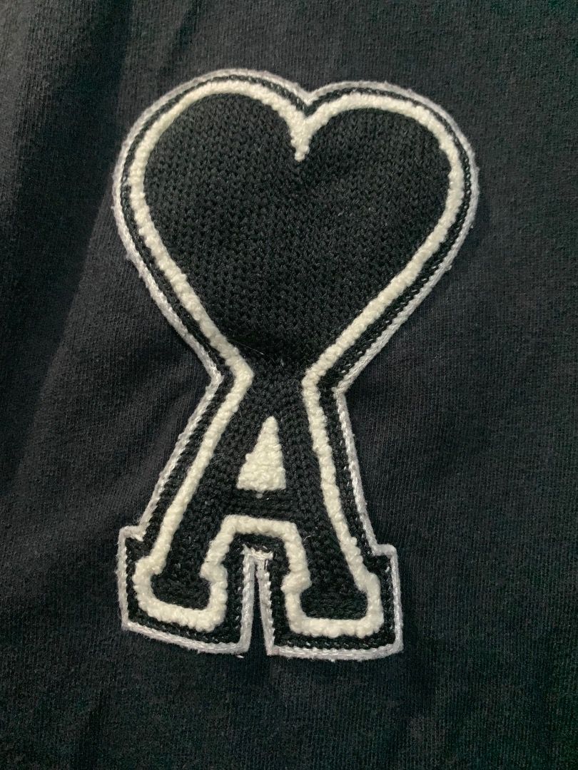 Ami Paris Heart Logo T-Shirt Black (Category: Shirts) located in Lucban. Submitted by mysticshark.0f6e1d (Listing ID 1470648421, Image 2). Description: Black t-shirt from Ami Paris. Large heart logo patch stitched on the chest. Made in Portugal from cotton fabric. Long washing tag attached inside showing brand details and care instructions..