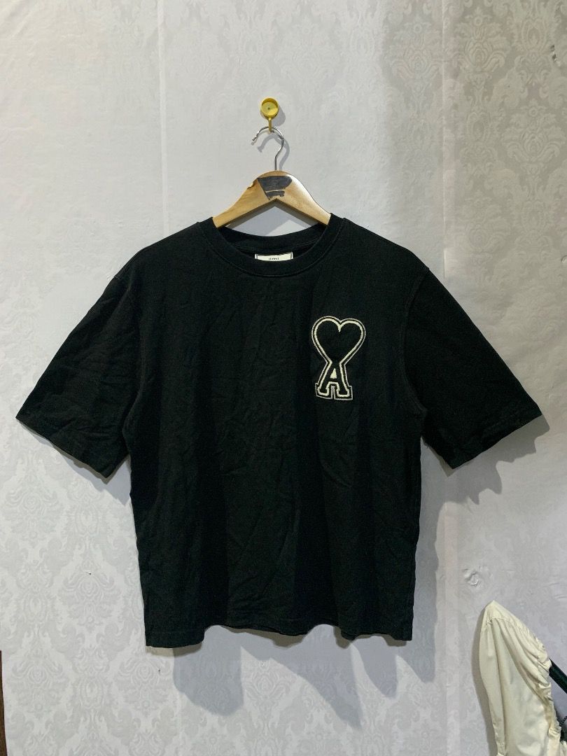 Ami Paris Heart Logo T-Shirt Black (Category: Shirts) located in Lucban. Submitted by mysticshark.0f6e1d (Listing ID 1470648421, Image 1). Description: Black t-shirt from Ami Paris. Large heart logo patch stitched on the chest. Made in Portugal from cotton fabric. Long washing tag attached inside showing brand details and care instructions..