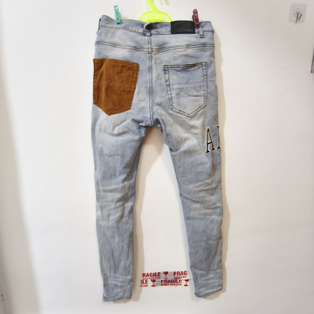 AMIRI Light Wash Distressed Patchwork Jeans Size 29 (Category: Jeans) located in Quezon City. Submitted by inrelationthrift (Listing ID 1470679416, Image 3). Description: - Brand: AMIRI - Style: Light wash distressed denim jeans with multi-color patchwork details - Size: 29-30(Waist measures approx. 15 inches flat) - Material: 98% cotton, 2% elastane - Features: Contrast brown back pocket, signature AMIRI embroidered lettering - Origin: Made in U