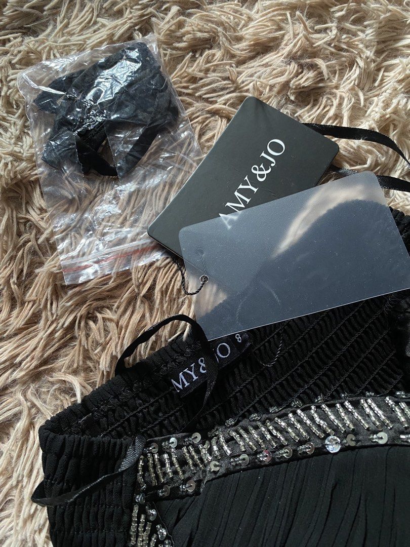 AMY & JO Black Beaded Strapless Dress (Category: Dresses) located in Manila. Submitted by stormibutterfly26 (Listing ID 1470592272, Image 3). Description: - Brand: AMY & JO - Color: Black with gorgeous silver beading and sequins on the sweetheart bodice - Design: Flowy pleated skirt for an elegant silhouette - Condition: Brand new with original tags attached, never worn - Extras: Includes detachable straps sealed in plastic.