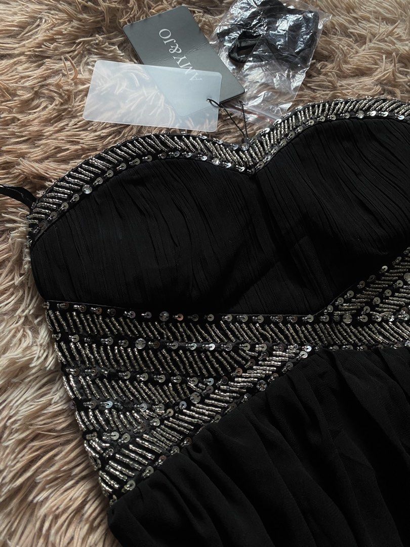 AMY & JO Black Beaded Strapless Dress (Category: Dresses) located in Manila. Submitted by stormibutterfly26 (Listing ID 1470592272, Image 2). Description: - Brand: AMY & JO - Color: Black with gorgeous silver beading and sequins on the sweetheart bodice - Design: Flowy pleated skirt for an elegant silhouette - Condition: Brand new with original tags attached, never worn - Extras: Includes detachable straps sealed in plastic.