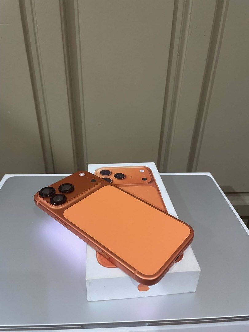 Apple iPhone (Category: iPhone 17 Series) located in Marikina City. Submitted by epicdog_9746d4 (Listing ID 1470596935, Image 2). Description: - Vibrant metallic orange finish on the back and edges - Equipped with a versatile triple camera setup - Flawless screen displaying home apps and settings - Comes with the original box - DM for inquiries and fast transactions!.