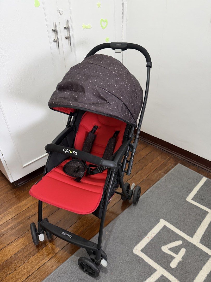 Apruva Keiryo Foldable Baby Stroller Lightweight (Category: Strollers) located in Mandaluyong City. Submitted by a.m.closet (Listing ID 1470597741, Image 1). Description: - Brand/Model: Apruva Keiryo Stroller - Color: Red and black with polka dot canopy - Portability: Folds down compactly for easy storage and travel - Comfort & Safety: Padded seat harness and front bumper bar installed - Canopy: Adjustable with a mesh viewing window - Storage: Co