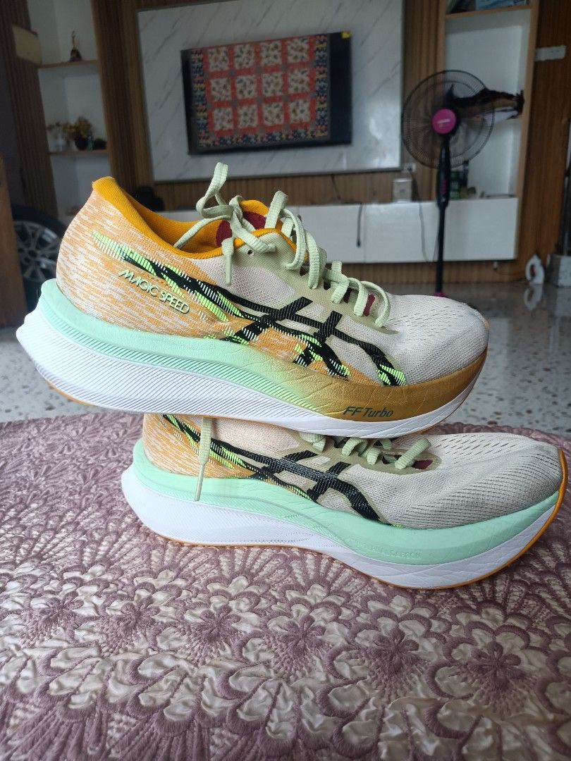 Asics Magic Speed running shoes (Category: Sneakers) located in Zamboanga. Submitted by caps_luck (Listing ID 1470569166, Image 3). Description: - Brand: Asics Magic Speed - Colorway: Vibrant multicolor with striking black branding, bright yellow collar, and mint green accents - Tech: FF Turbo cushioning and responsive carbon plate in the midsole - Upper: Breathable mesh - Condition: Worn a few times, uppers and soles still have plenty of life le
