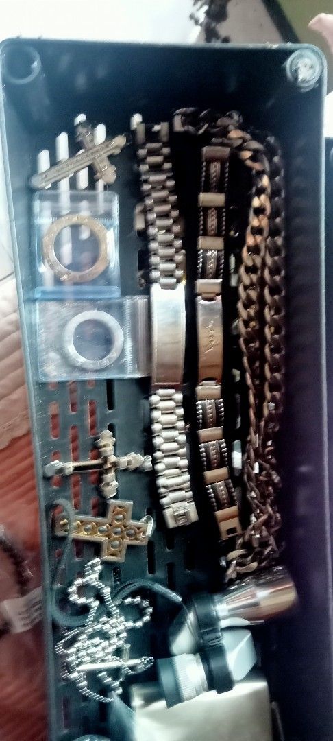 Assorted wristwatches chains and cross pendants bundle (Category: Women's Watches) located in Paranaque City. Submitted by dimaguilaa24827 (Listing ID 1470653495, Image 2). Description: - All-in-one jewelry and watch bundle - Multiple wristwatches with metal and rubber straps - Includes cross pendants, rings in small pm if int plastic cases, ID bracelets, and chunky chains - Assorted mixed metal finishes: silver, bronze, and gold tones - Sold tog