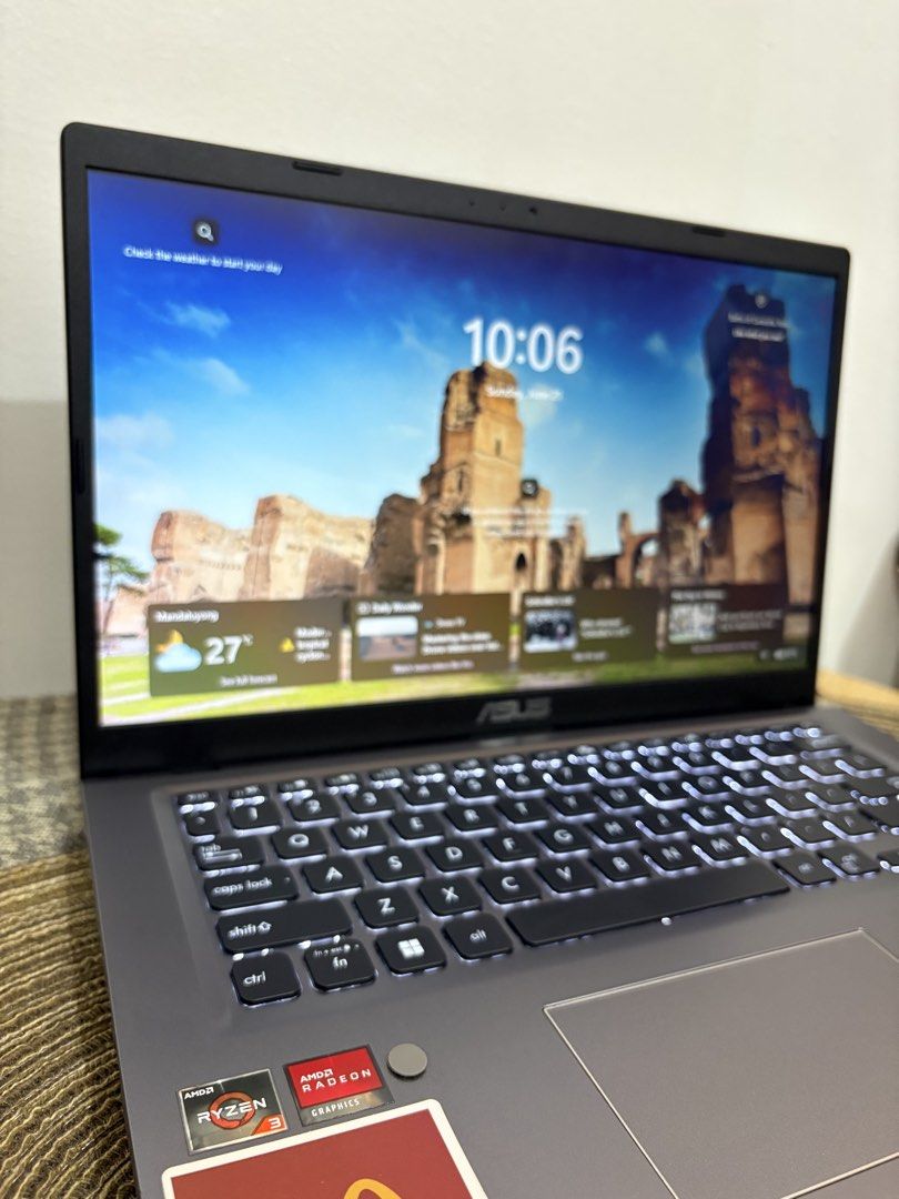 ASUS Laptop AMD Ryzen 3 Radeon Graphics (Category: Laptops & Notebooks) located in Makati City. Submitted by bryyyyyyyy16 (Listing ID 1470663731, Image 3). Description: - Brand/Model: ASUS Laptop (Gray chassis) - Processor: AMD Ryzen 3 - Graphics: AMD Radeon Graphics - Display: NanoEdge display - Keyboard: Backlit keyboard - OS: Windows - Customization: Lid is covered with various pop culture stickers; McDonald's logo sticker on the palm rest - C