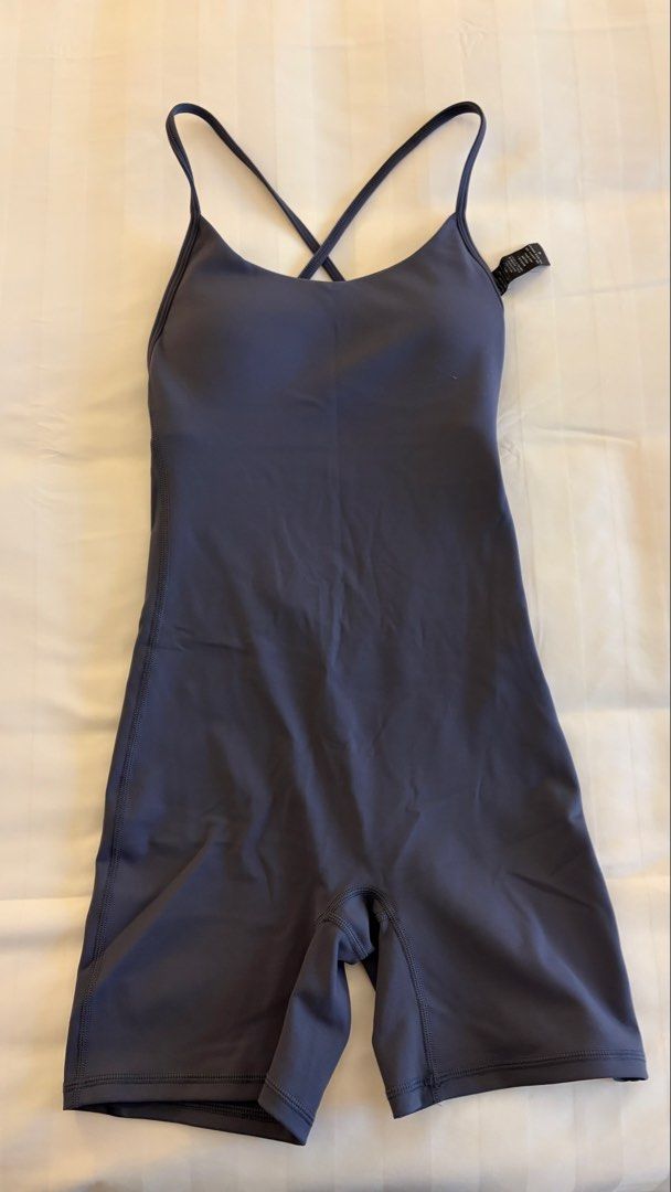 Athletic Yoga Romper Dark Grey Strappy Back (Category: Activewear) located in Manila. Submitted by letmeclean (Listing ID 1470668291, Image 2). Description: - Color: Dark Grey - Style: Workout romper with mid-thigh biker shorts - Support: Built-in bra with removable padding - Design: Scoop neckline and trendy crisscross thin back straps - Fabric: Soft, highly stretchy, and comfortable - Ideal for: Yoga, pilates, gym sessions, or casual wear - Con