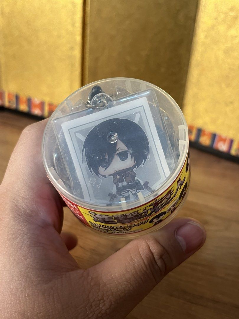 Attack on Titan 3way Strap Collection Mikasa Ackerman (Category: Figurines & Statues) located in Gapan. Submitted by lunashop14 (Listing ID 1470628821, Image 1). Description: - Item: Attack on Titan 3-way strap capsule toy - Character: Mikasa Ackerman - Condition: Brand new, unopened capsule packaging - Inclusions: Original clear plastic container, yellow and red label wrapper, and original strap attachment - Authenticity: 100% official merchandi