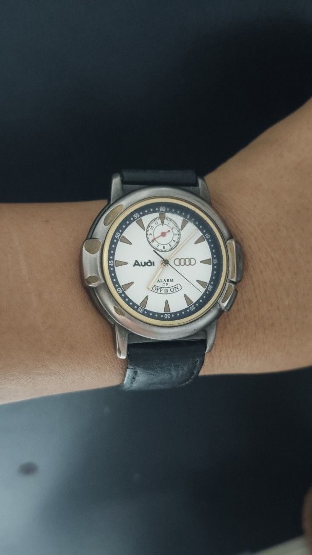 Audi Alarm Watch with Black Leather Strap (Category: Luxury Watches) located in Taguig. Submitted by mercyeugen28914 (Listing ID 1470683646, Image 1). Description: - Brand: Audi - Dial: White with gold bezel accents and sub-dial at 12 o'clock - Strap: Black leather - Special Feature: Alarm function with toggle at the bottom of the dial - Condition: Minor wear on the case and strap - Deal: Ready to ship or meet-up, message for details!.