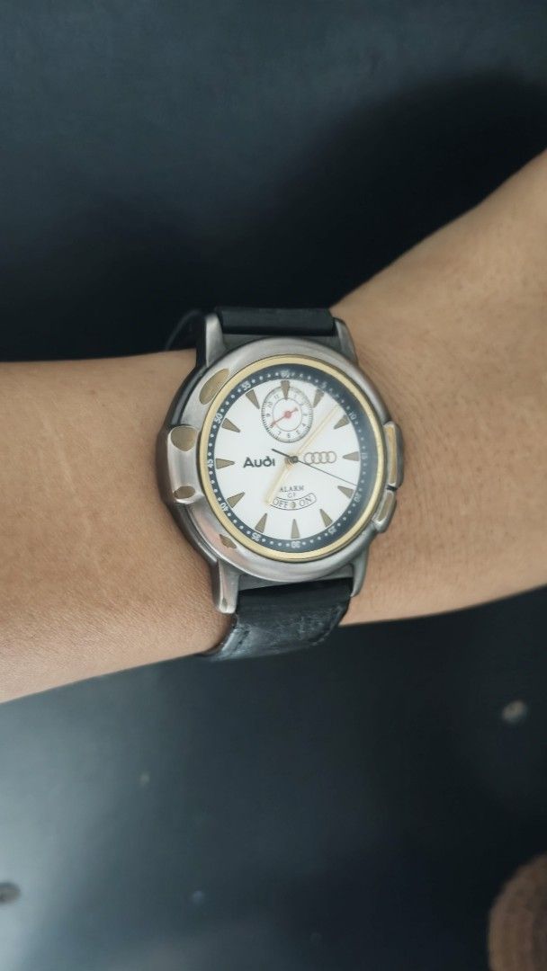 Audi Alarm Watch with Black Leather Strap (Category: Luxury Watches) located in Taguig. Submitted by mercyeugen28914 (Listing ID 1470683646, Image 3). Description: - Brand: Audi - Dial: White with gold bezel accents and sub-dial at 12 o'clock - Strap: Black leather - Special Feature: Alarm function with toggle at the bottom of the dial - Condition: Minor wear on the case and strap - Deal: Ready to ship or meet-up, message for details!.