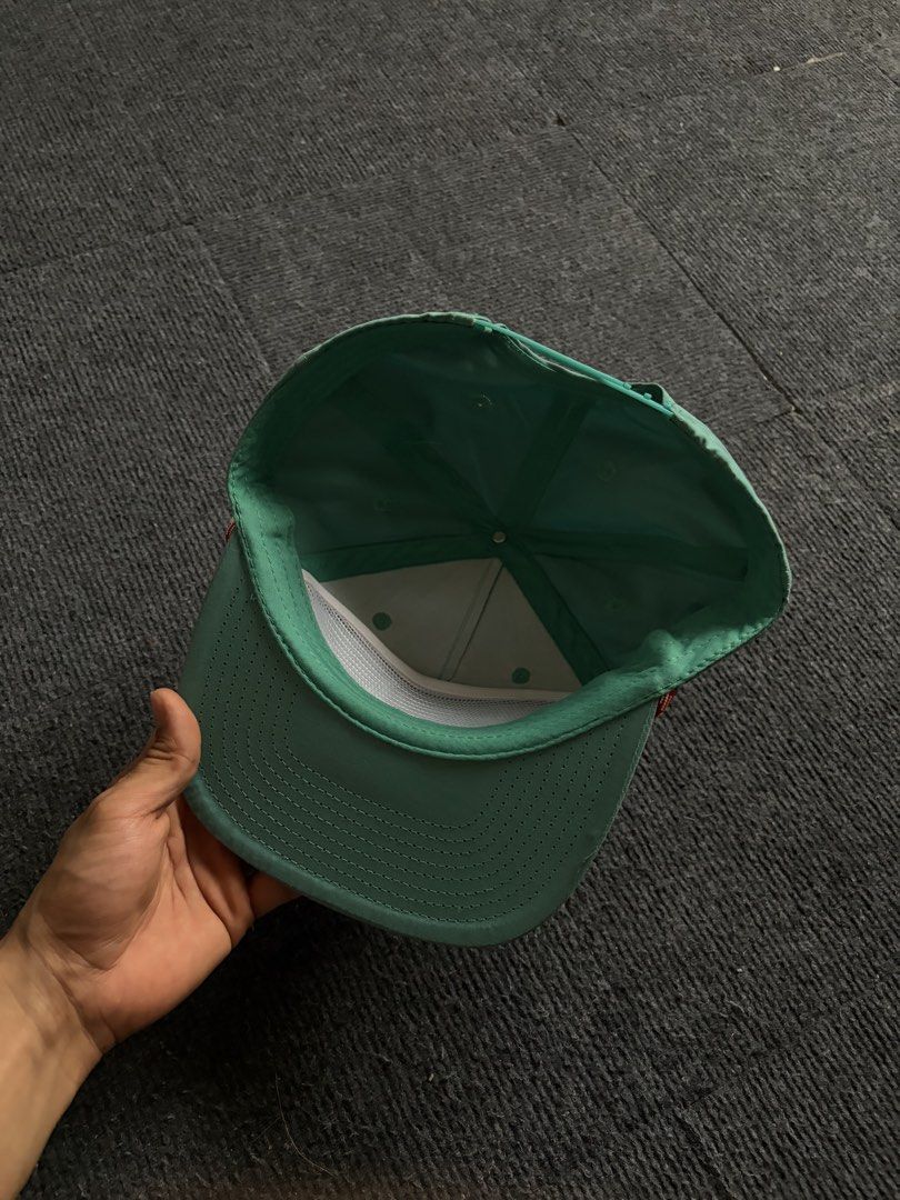 Austin Beerworks Green Snapback Hat (Category: Caps & Hats) located in Manila. Submitted by toys_hats005 (Listing ID 1470629154, Image 3). Description: - Brand: Austin Beerworks - Style: Green snapback cap with adjustable snap closure - Details: Woven front patch with red lettering, red and white twisted rope along the brim - Interior: Clean lining with white mesh structure inside front panels - Condition: Great overall condition.