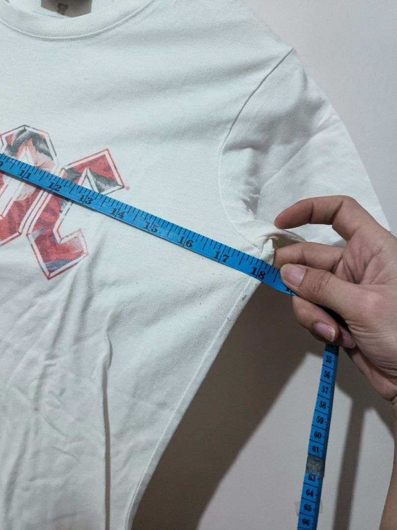 Authentic AC/DC Mono Leopard Print Logo White T-Shirt (Size L) (Category: Shirts) located in San Leonardo. Submitted by burgossanleonardo.12345 (Listing ID 1470679079, Image 3). Description: [AUTHENTIC BAND MERCH] Official licensed AC/DC short-sleeve graphic shirt. Features the iconic rock band logo on the front with a stylish monochromatic pink leopard print fill pattern inside the lettering. Cut from "The Relaxed Tee" collection line, offering 