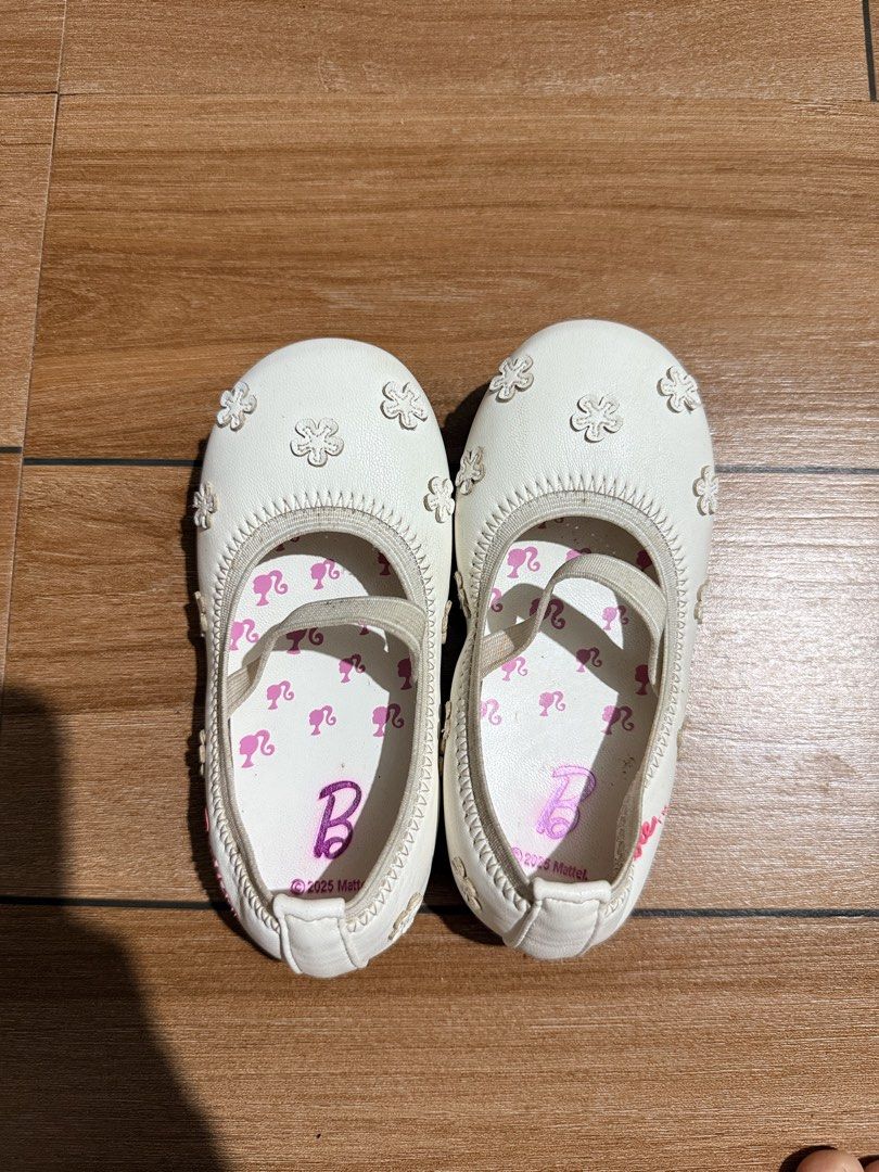 Authentic Barbie shoes (Category: Babies & Kids Fashion) located in Cagayan de Oro. Submitted by shincin11 (Listing ID 1470662201, Image 3). Description: - Item: White Barbie Mary Jane flats for kids - Size: 24 (marked on outsole with cute flower and heart tread) - Design: Adorable flower appliqués on the upper with pink Barbie silhouettes and branding on the inner sole - Convenience: Elastic strap across the top for easy slip-on and off - Condit