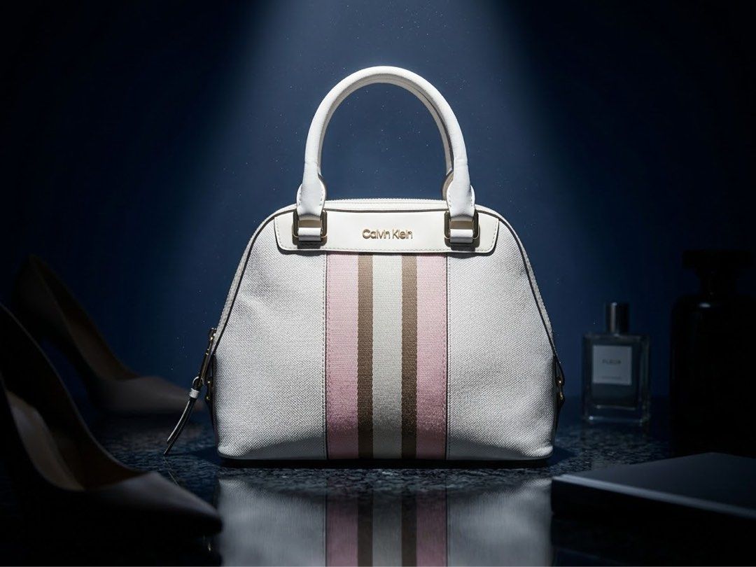 Authentic Calvin Klein US Stripe Dome Satchel / Handbag (Category: Luxury Bags & Wallets) located in Mandaluyong City. Submitted by josa_xox0i8 (Listing ID 1470696015, Image 1). Description: ✨ AUTHENTIC CALVIN KLEIN STYLISH DOME SATCHEL BAG ✨ Bought directly from the US! Gorgeous neutral white/cream tone with signature webbing stripes and gold-tone hardware—perfect for everyday casual or work wear! 📌 DETAILS: Brand: Calvin Klein Condition: Unuse
