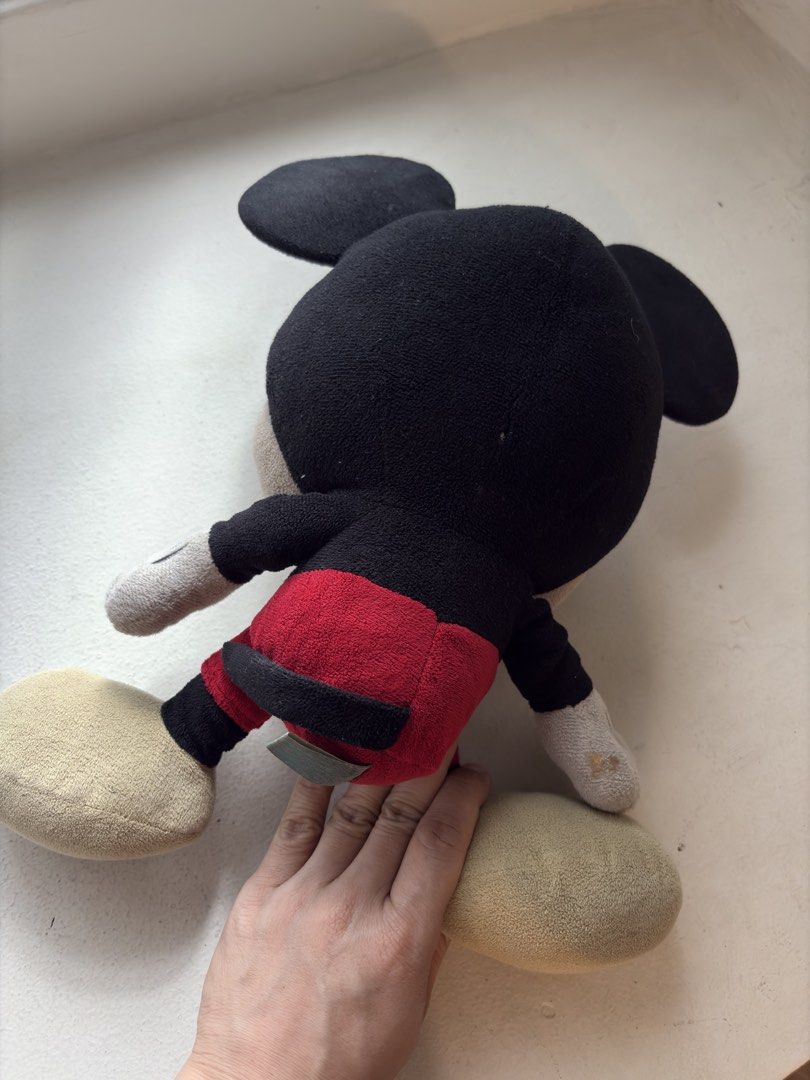 Authentic Disney Merchandise Mickey Mouse Plush Toy (Category: Plushies & Soft Toys) located in Mandaluyong City. Submitted by material_boi (Listing ID 1470585371, Image 2). Description: Bought in Disneyland HK years ago for I think ₱2k plus. Malambot. Di siya nakakatayo, upo lang. Naka-stock lang to sa kotse ko. Issues: medyo marumi siya from dust, dry clean nyo na lang. Then last pic shows parang may galos siya sa likod ng isang kamay. Perfect 